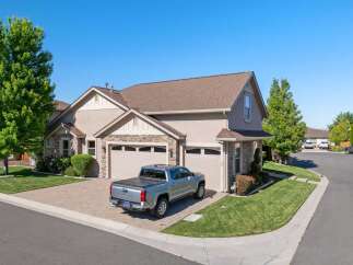 Discover this stunning home featuring a modern silver pickup truck parked in the driveway.