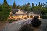Discover this stunning home featuring a welcoming covered porch with ample seating, perfect for enjoying the serene surroundings.