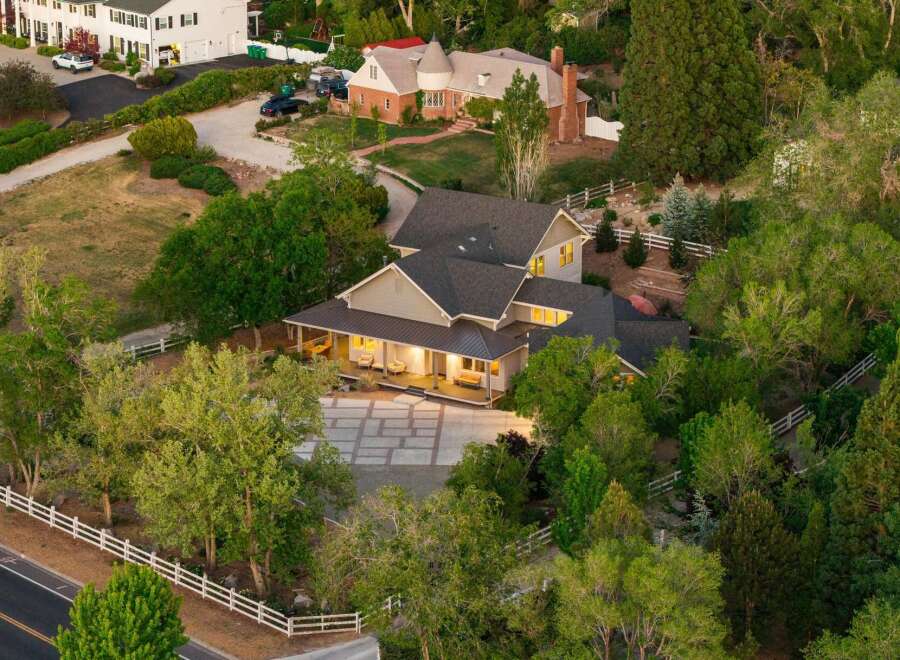 Discover this stunning property featuring a sprawling estate with a charming wrap-around porch, perfect for enjoying the serene surroundings.