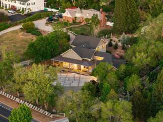Discover this stunning property featuring a sprawling estate with a charming wrap-around porch, perfect for enjoying the serene surroundings.