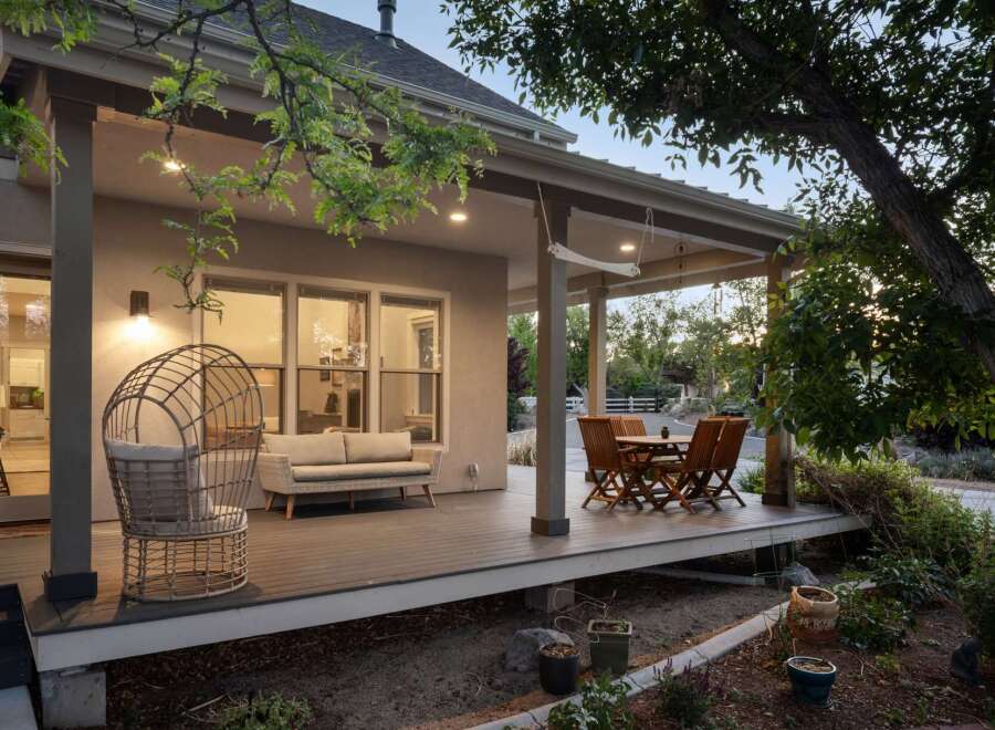 Enjoy outdoor living on this spacious covered deck, perfect for entertaining or relaxing.