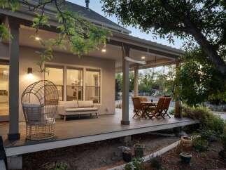 Enjoy outdoor living on this spacious covered deck, perfect for entertaining or relaxing.