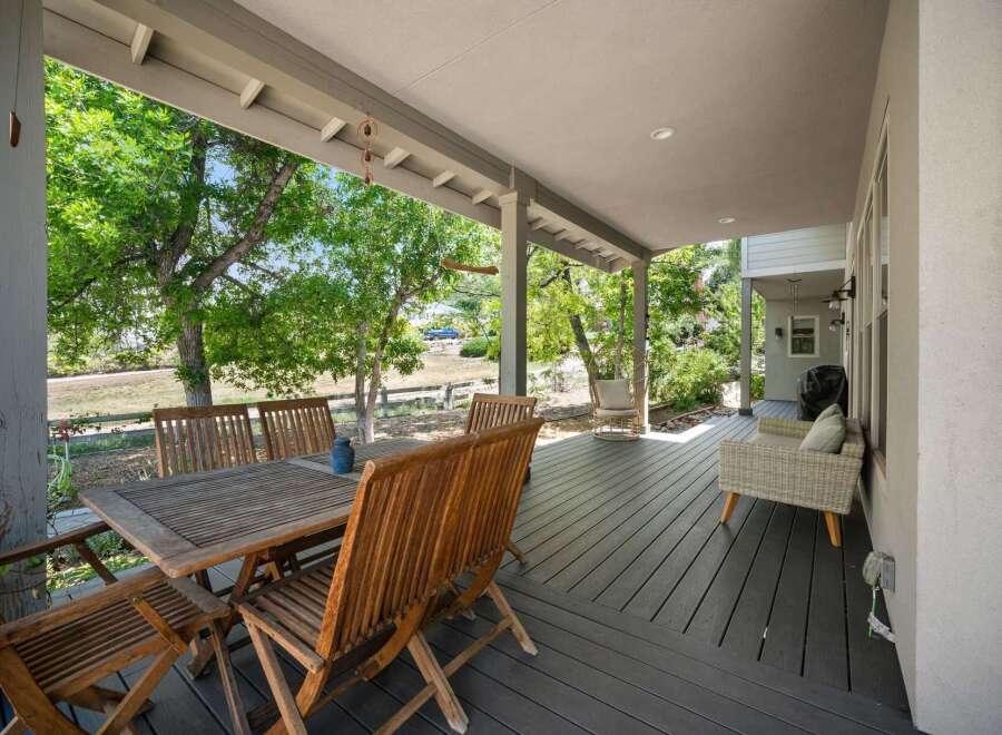 Enjoy outdoor living on this spacious covered deck, perfect for al fresco dining or relaxing with a view.