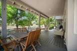 Enjoy outdoor living on this spacious covered deck, perfect for al fresco dining or relaxing with a view.
