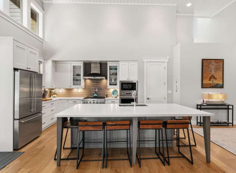 Experience modern luxury in this stunning open-concept kitchen, featuring a spacious island with bar seating perfect for entertaining.