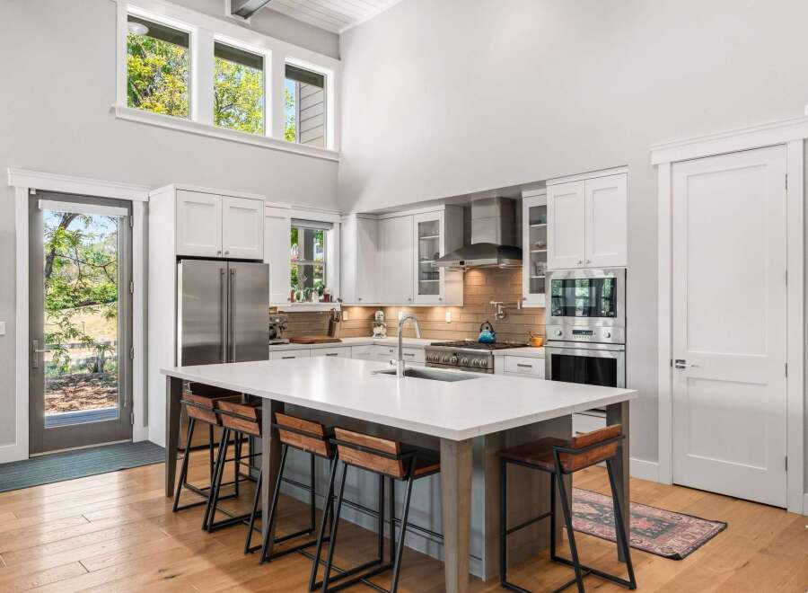 Experience modern living in this stunning kitchen featuring a large island with bar seating, perfect for entertaining.
