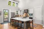 Experience modern living in this stunning kitchen featuring a large island with bar seating, perfect for entertaining.