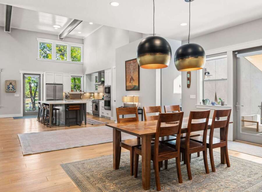 Experience modern living in this stunning open-concept home, featuring a gourmet kitchen with a large island and sleek stainless steel appliances.