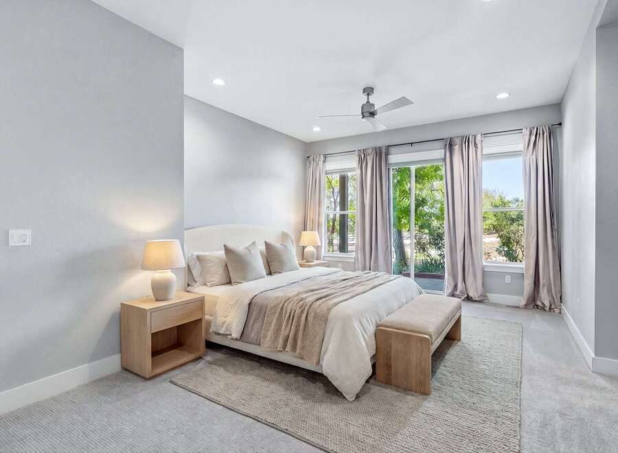 Experience modern luxury in this serene bedroom, featuring a plush king-size bed adorned with soft linens and accent pillows.