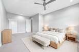 Experience modern comfort in this serene bedroom, featuring a plush king-sized bed adorned with elegant throw pillows and a cozy duvet.