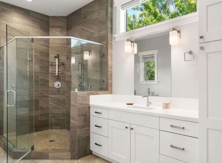 Experience luxury in this stunning bathroom featuring a spacious glass-enclosed shower with elegant tilework and modern fixtures.