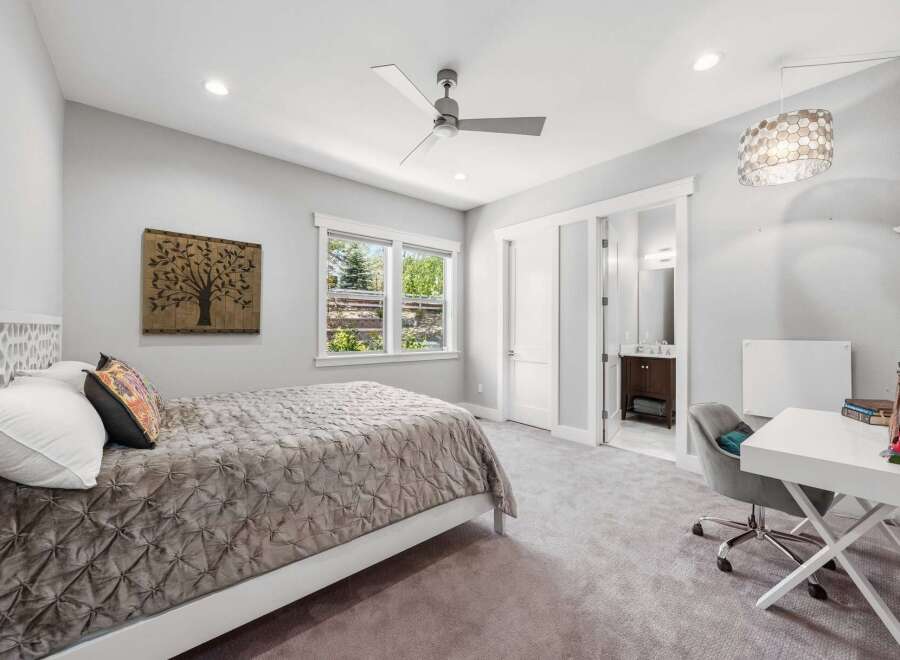 This inviting bedroom features a comfortable bed with a plush comforter and decorative pillows, perfect for relaxation.