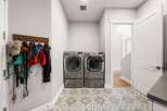 This laundry room features a pair of modern LG front-load washers and dryers, perfect for handling large loads.