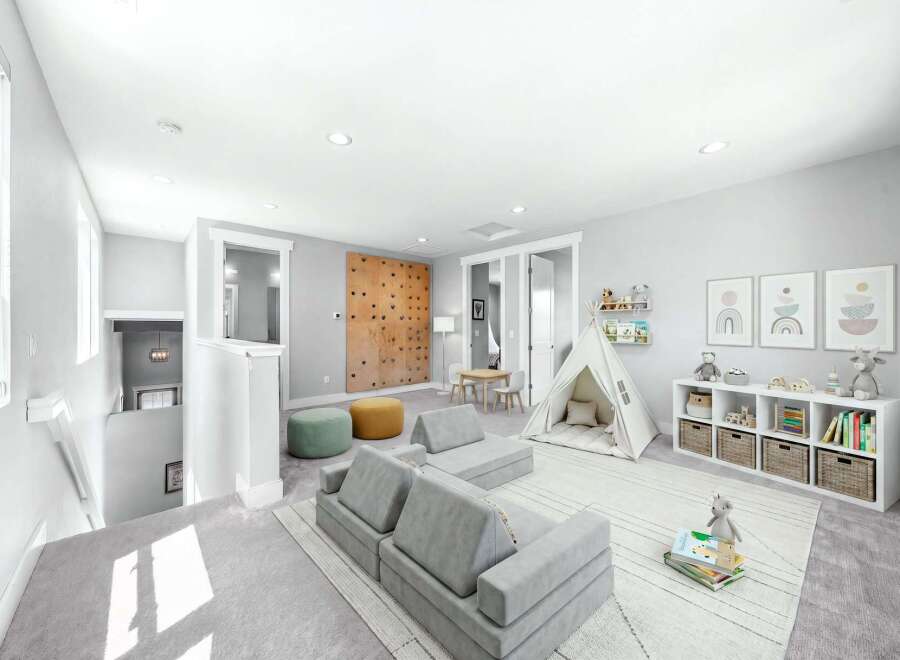 This bright and airy playroom is designed for fun and imagination, featuring a climbing wall, a cozy play tent, and modular seating.