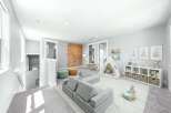 This bright and airy playroom is designed for fun and imagination, featuring a climbing wall, a cozy play tent, and modular seating.