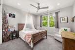 This charming bedroom features a cozy wooden bed adorned with a sheer canopy, creating a whimsical atmosphere.
