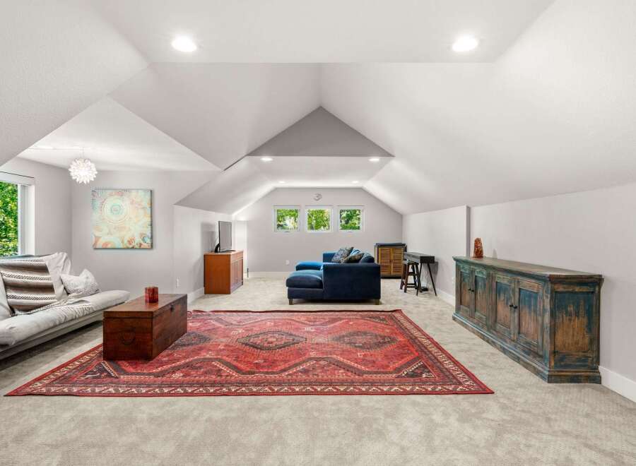 Discover this spacious and inviting bonus room, perfect for a home theater, playroom, or additional living space.