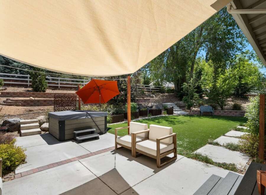 Enjoy ultimate relaxation in this backyard oasis, featuring a luxurious hot tub perfect for unwinding.