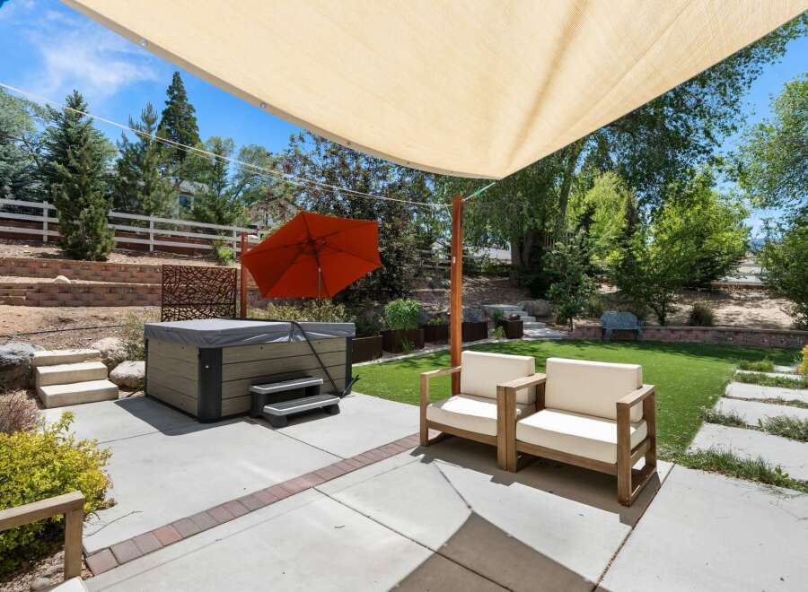 Enjoy ultimate relaxation in this backyard oasis, featuring a luxurious hot tub perfect for unwinding.