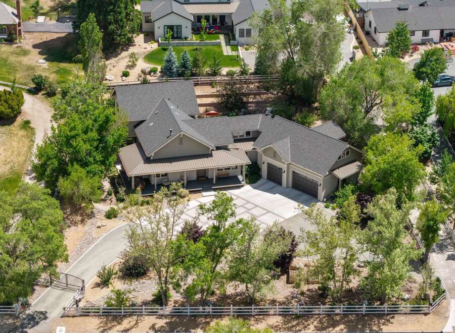 Discover this stunning property featuring a spacious main house with a welcoming porch and a detached three-car garage.