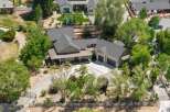 Discover this stunning property featuring a spacious main house with a welcoming porch and a detached three-car garage.