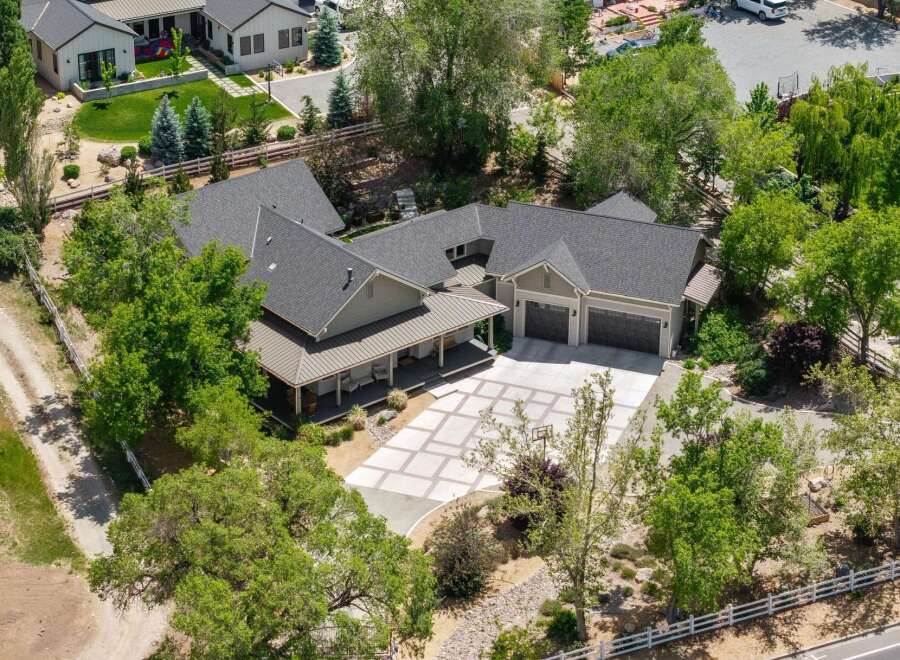 Discover this stunning property featuring a spacious main house with a welcoming covered porch and a detached garage.