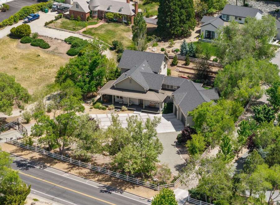 Discover this stunning property featuring a spacious home with a welcoming covered porch, perfect for enjoying the serene surroundings.