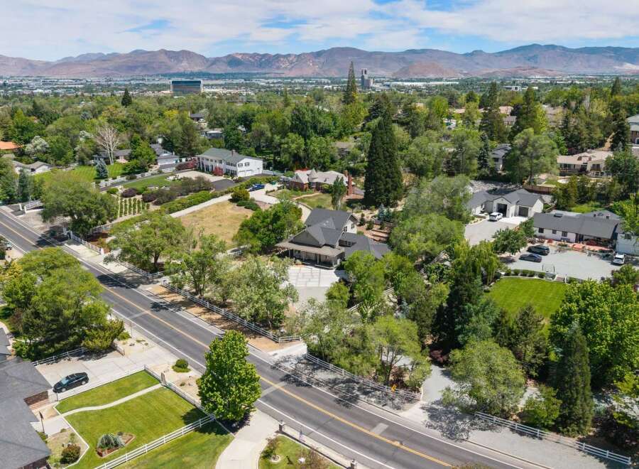 Discover this expansive estate nestled amidst lush greenery and mature trees, offering a serene and private retreat.