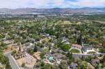 Discover this stunning aerial view showcasing a picturesque neighborhood with lush greenery and well-maintained homes.