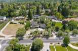 Discover this stunning estate featuring a spacious, modern home with a three-car garage, nestled amidst mature trees and lush landscaping.