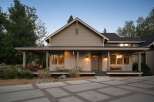 This charming home features a welcoming covered porch with ample seating, perfect for enjoying the outdoors.
