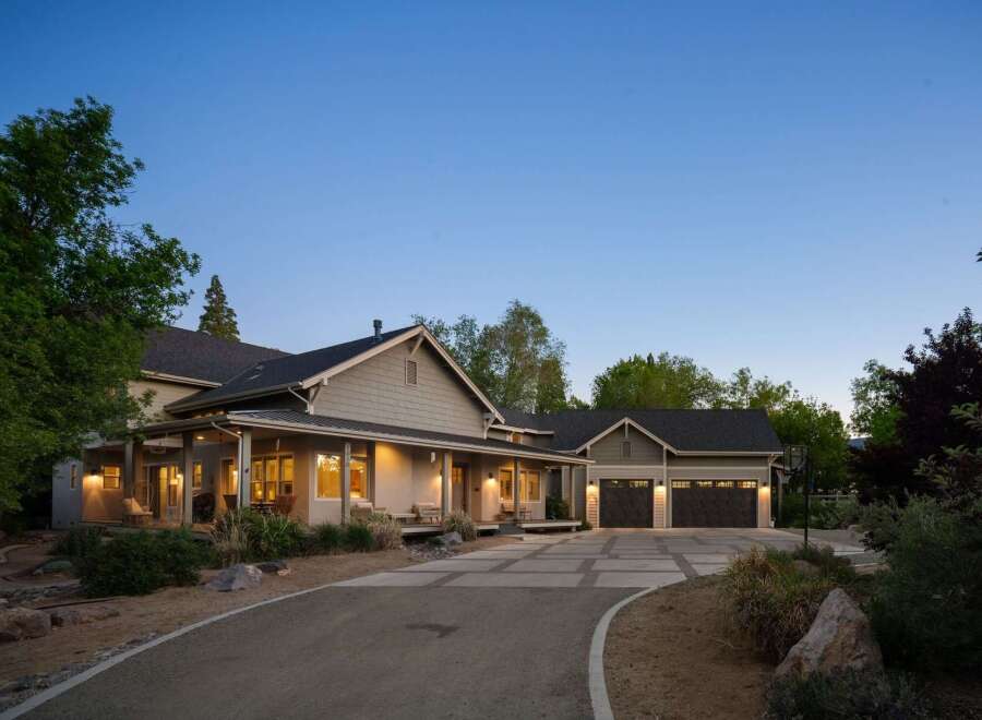 Discover this stunning modern farmhouse-style home featuring a welcoming wrap-around porch and a spacious three-car garage.