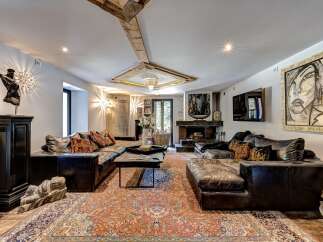 Experience luxurious living in this spacious living room, featuring a large, plush sectional sofa perfect for gatherings.
