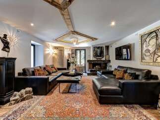 Experience luxurious living in this spacious living room, featuring a large, plush sectional sofa perfect for gatherings.