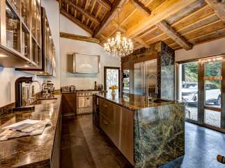 Experience luxury in this stunning kitchen featuring a dramatic marble island and high-end stainless steel appliances.