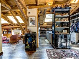 Experience rustic charm and sophisticated living in this attic loft, featuring exposed wooden beams and skylights that flood the space with natural light.