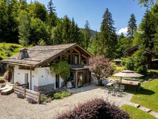 Nestled amidst lush greenery, this charming chalet offers a serene mountain retreat.