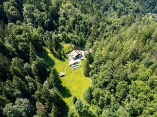 Experience ultimate privacy and tranquility in this stunning mountain retreat, nestled within a lush, verdant forest.