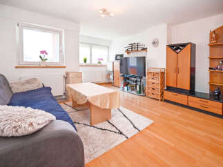 This inviting living room features a comfortable sofa with plush cushions, perfect for relaxation.