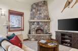 Cozy up by the stunning floor-to-ceiling stone fireplace, perfect for chilly mountain evenings.