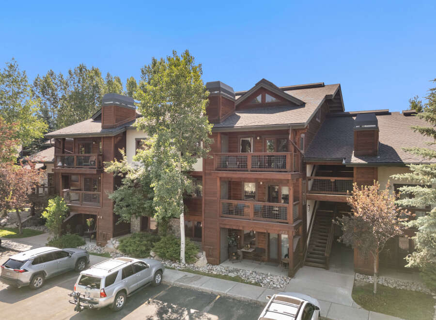 Experience luxury mountain living in this stunning timber-frame condo, featuring multiple balconies with scenic views.