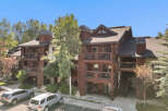 Experience luxury mountain living in this stunning timber-frame condo, featuring multiple balconies with scenic views.