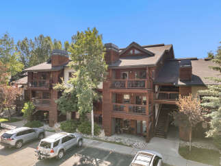 Experience luxury mountain living in this stunning timber-frame condo, featuring multiple balconies with scenic views.