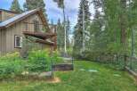Nestled amidst a serene forest, this charming home offers a tranquil retreat with its rustic exterior and lush surrounding greenery.