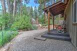 Experience rustic charm with this inviting porch, featuring a unique twig chair perfect for enjoying the serene, wooded surroundings.
