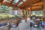 Enjoy outdoor living in this covered patio space, complete with a gas grill and comfortable seating.