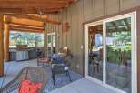 Enjoy outdoor living on this covered patio, complete with a built-in grill and comfortable seating.