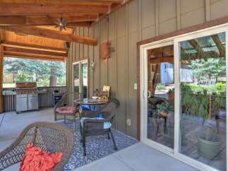 Enjoy outdoor living on this covered patio, complete with a built-in grill and comfortable seating.