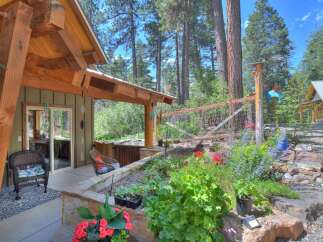 Enjoy outdoor living with this charming property featuring a covered patio, a relaxing hot tub, and a beautifully landscaped garden.