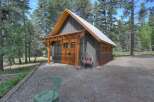 Discover this charming cabin nestled amongst tall pine trees, offering a serene retreat.